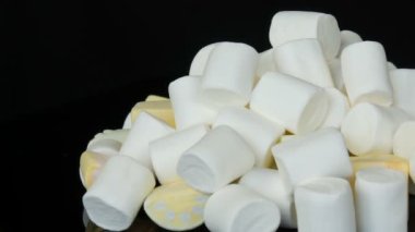 Ayna yüzeyinde ve siyah arka planda çok renkli mini Marshmallow şekerler. Diyabet sorunu ve tatlı aşırı yeme.