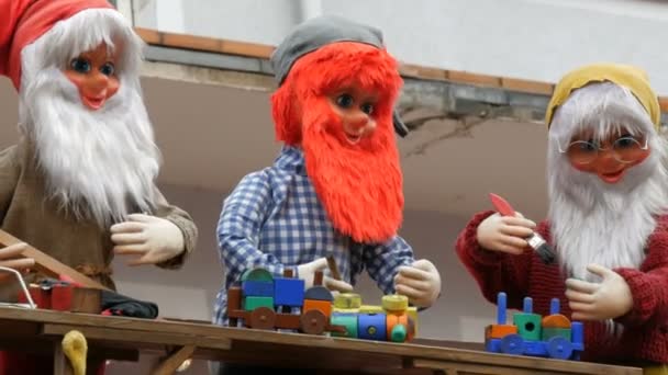 Hareketli bebekler Avrupa 'da çocuk Noel piyasasının Kiosk çatısında komik gnomes. — Stok video