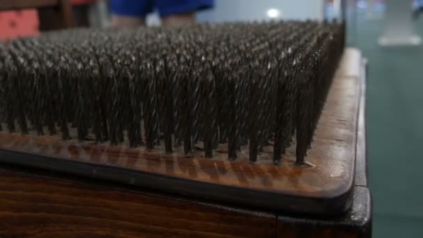 Chair with metal spikes or with iron nails on a seat close up view. Concept of physics. Museum of Science — Stock Video