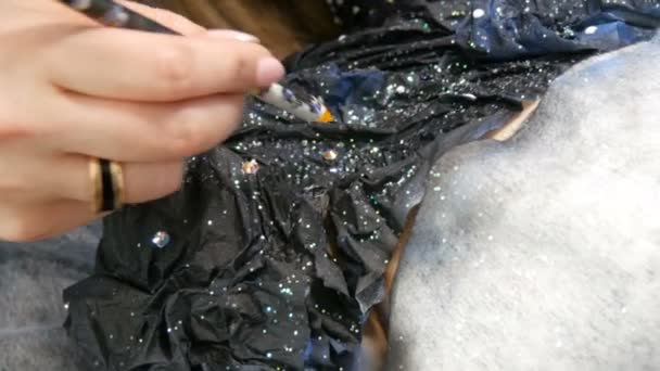 High fashion. Designer prepares image of a model alien girl in a black sparkling rhinestones, sparkles, metal butterflies at studio — Stock Video