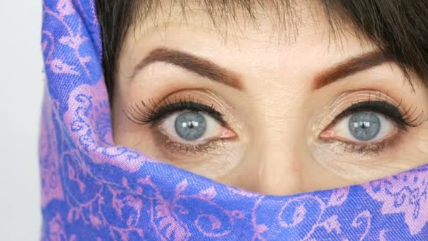 Πορτρέτο ενός αραβικού μεσαίου ηλικίας ενήλικη γυναίκα με ασυνήθιστο όμορφο μεγάλο μπλε μάτια με μεγάλες βλεφαρίδες σε παραδοσιακό ισλαμικό πανί μπούρκα ή burqa. Κοντινό κομμάτι της όμορφης μουσουλμανικής γυναίκας — Αρχείο Βίντεο