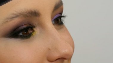 Profesyonel makyaj sanatçısı göz makyajı modeli yapar. Akşam makyajlı yüz modeli. Yakından bak.