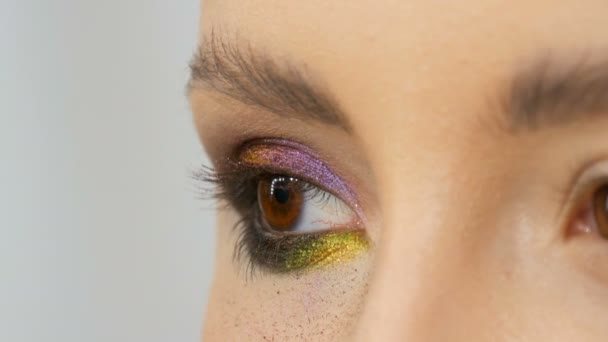 Artista de maquillaje estilista profesional hace modelo de maquillaje de ojos. Modelo de cara con maquillaje de noche vista de cerca — Vídeo de stock