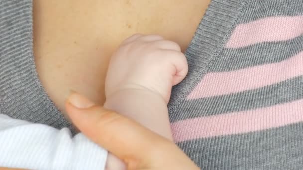 Mão pequena de um bebê recém-nascido de dois meses no peito da mãe — Vídeo de Stock