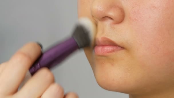 Artista de maquillaje profesional aplica corrector de fundación o resaltador a la cara de modelos coreanos asiáticos con cepillo especial — Vídeos de Stock