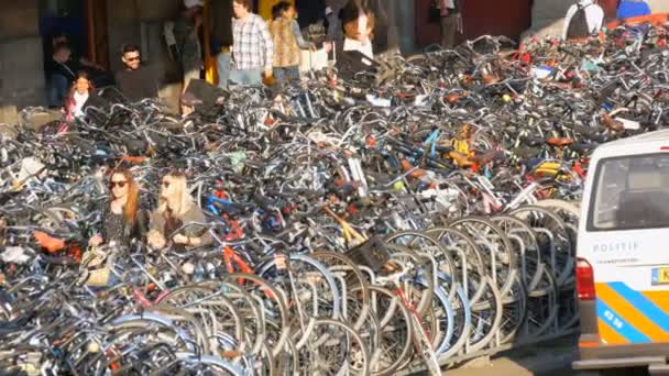 Amsterdam, Netherlands - April 21, 2019: Parking for bicycles. Many different bicycles parked on a street in special parking lots. The problem of bicycle overload in the country — Stock Video