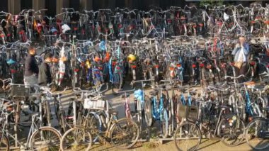 Amsterdam, Hollanda - 21 Nisan 2019: Bisiklet ler için otopark. Birçok farklı bisiklet özel otoparklarda bir sokakta park. Ülkede bisiklet aşırı sorunu