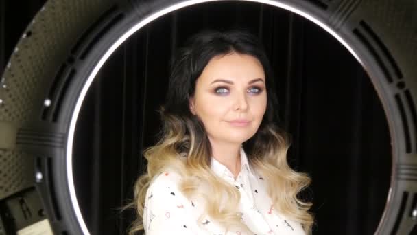 Beautiful young woman with long hair extensions dyed black and white ombre and beautiful bright evening professional makeup smoky eyes posing in front of camera — 비디오