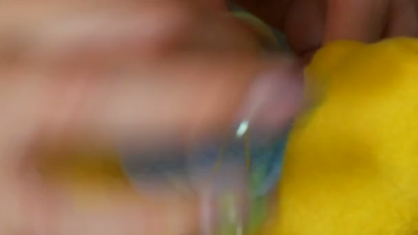 En sömmerskas kvinnliga händer med manikyr syr fast en blå bit av en gul leksak. Syverkstad, leksaksfabrik — Stockvideo