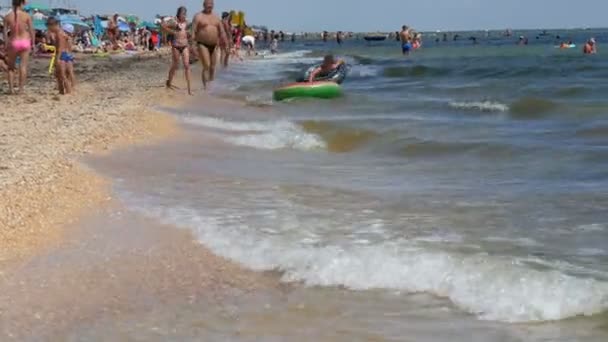 Schastlivtsevo, Ukrajina - 2. srpna 2020: Mnoho lidí na pláži odpočívá na Azovském moři. Plno slunečných pláží. Lidé plavou a odpočívají v moři. Pěkné místo na dovolenou — Stock video