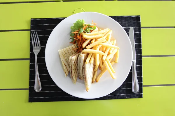 Restaurant menu. French fries with bread and salad. Table setting in a restaurant.