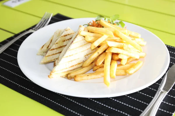 Restaurant menu. French fries with bread and salad. Table setting in a restaurant.