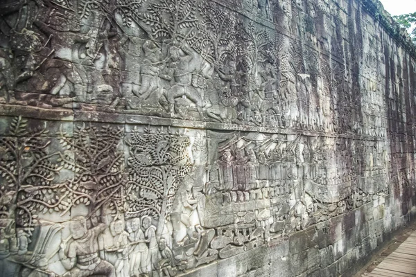 Bas-reliefs on the walls of the Angkor. Stone Gate of Angkor Thom in Cambodia, Siem Reap Angkor