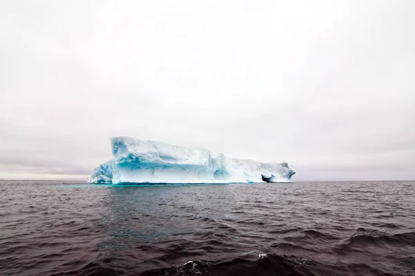 Arctic iceberg in the ocean. Arctic landscape, arctic tundra and ice of the Arctic Ocean.