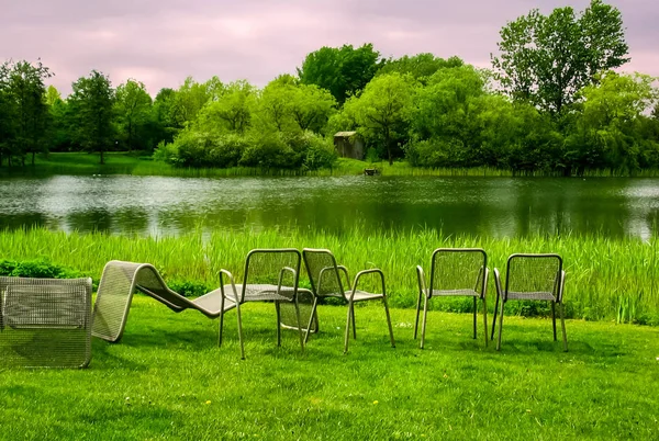 Chairs on the shore of the pond. Camping with chairs