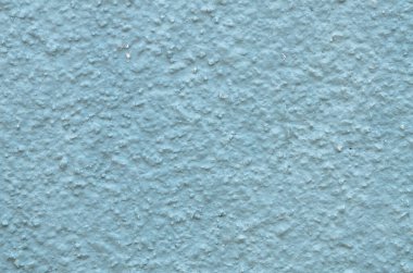 Boyanmış bir duvarın eğri tepeleri ve vadileri tutarlı ve çok yönlü bir yapı arkaplanı sunuyor..