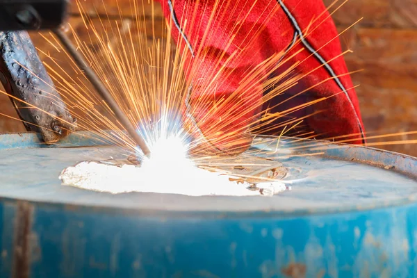 Worker with red glove to protect spark light with welding Proces Stock Image