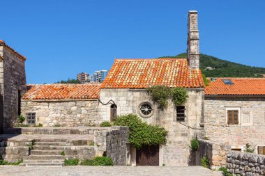 Karadağ 'ın antik Budva kentindeki sokaktaki eski tarihi taş binalar.