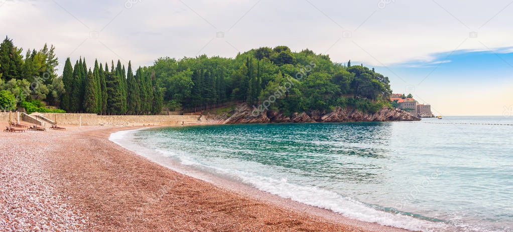Pebble beach on Adriatic sea, near the Sveti Stefan island in Montenegro, gorgeous summer seascape and nature landscape.