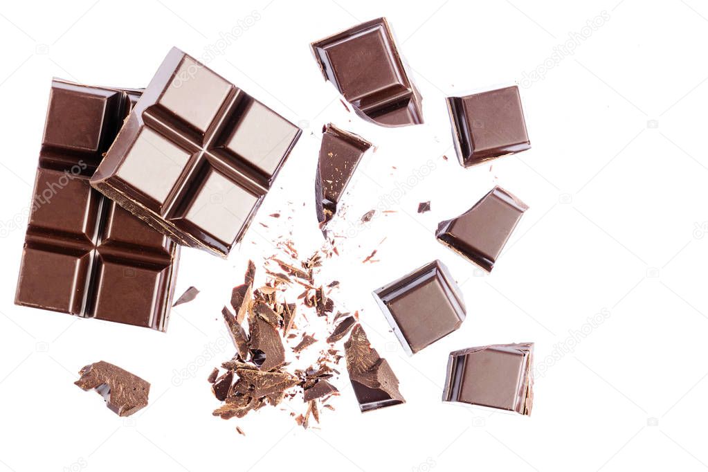 Chocolate cubes, pieces of bitter, dark chocolate, isolated on white background, top view.