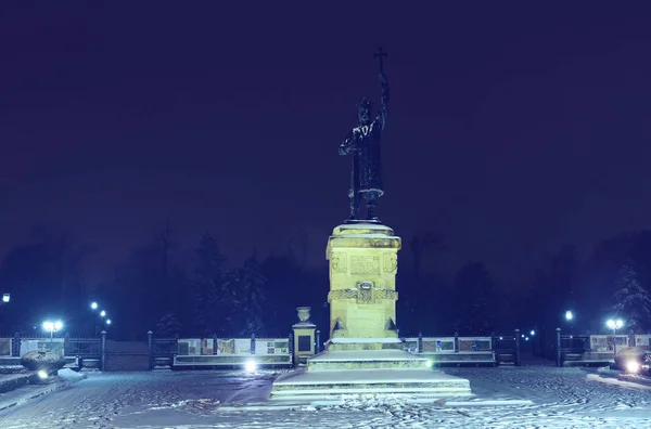 Stefan statue and square in central park with snow at night, in Chisinau, Moldova