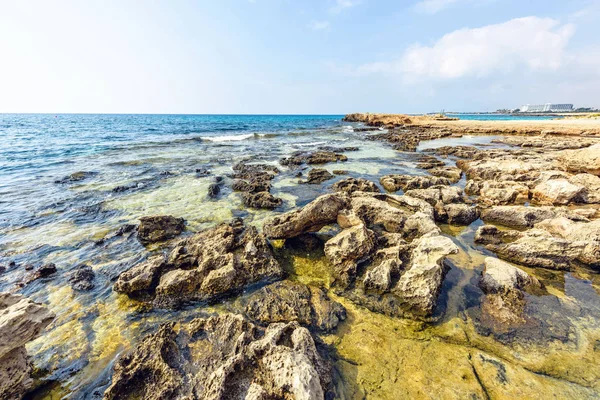 stock image Daylight view to Nissi Beach with colorful bright blue rocky water and sky with clouds. Negative copy space, place for text. Ayia Napa, Cyprus