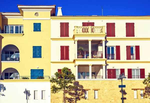 Daylight front view to rich house buildings facade. Bright blue clear sky on background. Limassol, Cyprus