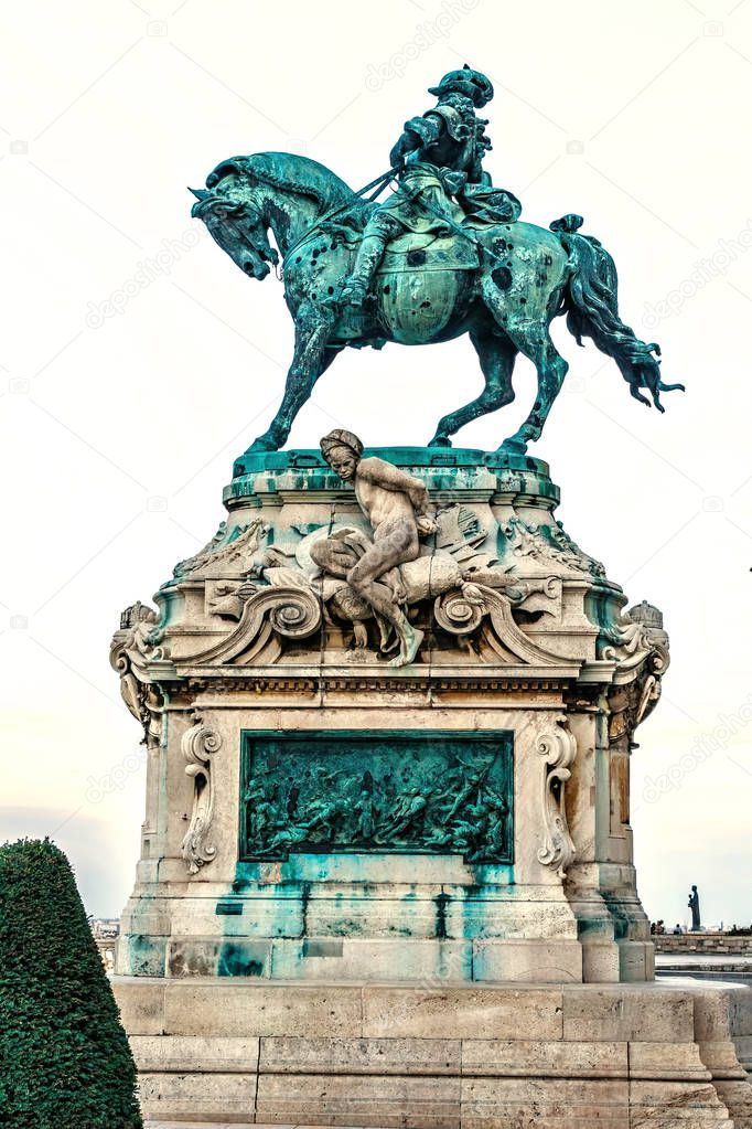 Equestrian statue of Prince Eugene of Savoy at sunset. Isolated background. Warm cloudy sky. Budapest, Hungary