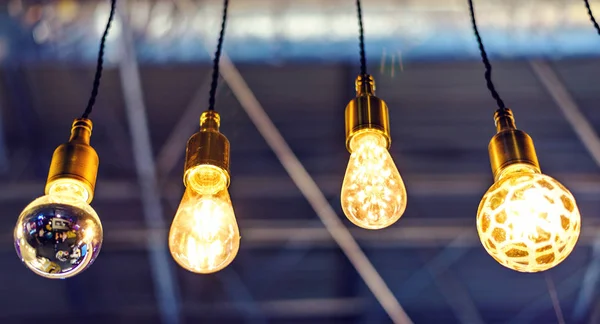 Abstract warm lights hanging from ceiling in local restaurant. Close-up shot with blurred background. Negative copy space, place for text. Chisinau, Moldova