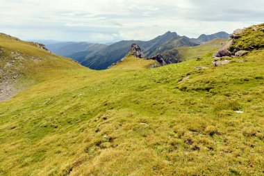 Bulutlu bir günde Paltinului eyer. Yeşil çim ve parlak gökyüzü. Fagaras dağlar, Romanya