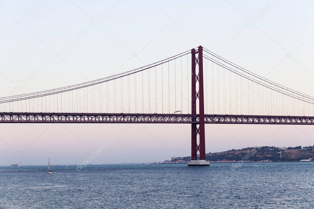 The 25 de Abril steel suspention bridge in Lisbon at sunset, Portugal