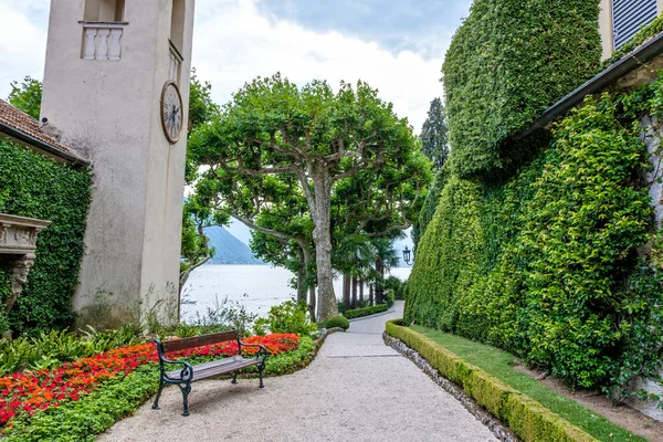 Villa del Balbianello green garden with chapel. Clouds on background. Lenno, Italy