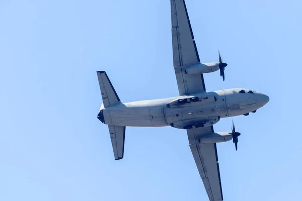 big plane flies against the background of the blue sky