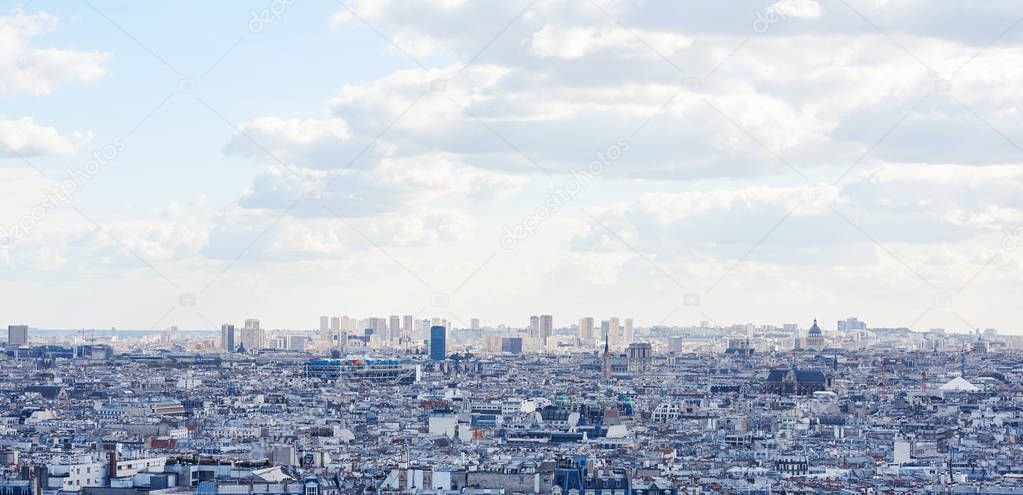Paris cityscape in a cloudy day with Eiffel Tower on background. France