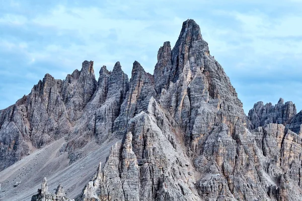 Tre Cime di Lavaredo mountains at daylight. Blue sky with clouds on background. Italy beauties
