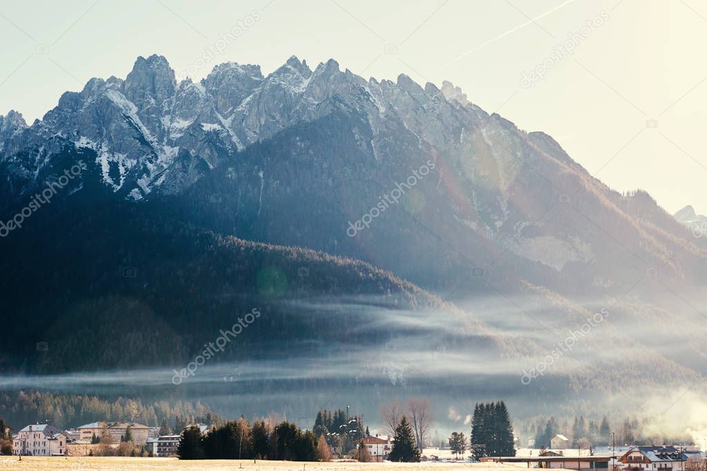 Toblach city and mountains covered in snow at sunset. Italy beauties