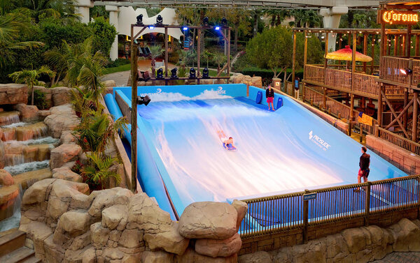 People practice surfing in wave pool