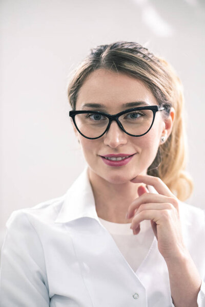 Young caucasian female dentist at the workplace in a dentistry cabinet