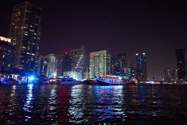 Dubai Marina at night with colorful touristic boats — Stock Photo, Image