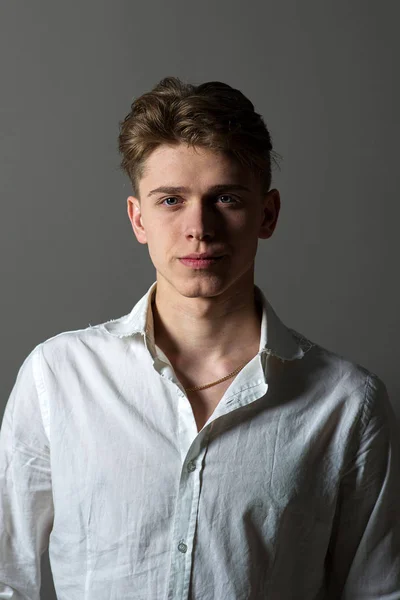 Portrait shot of a young caucasian man with blue eyes and blonde hair