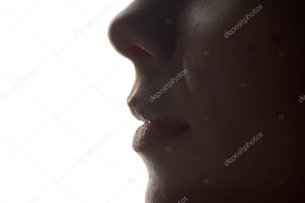 Close up shot of lips and nose of a young woman