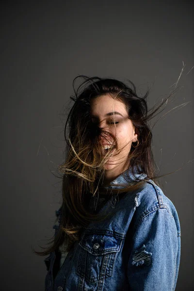 Young caucasian girl with strike hair posing on grey background — Stock Photo, Image