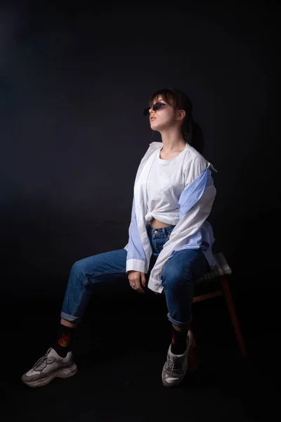 Caucasian Girl in white shirt with black sunglasses posing in the studio — Stock Photo, Image