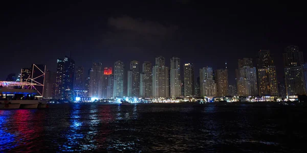 Dubai Marina at night with colorful touristic boats — Stock Photo, Image