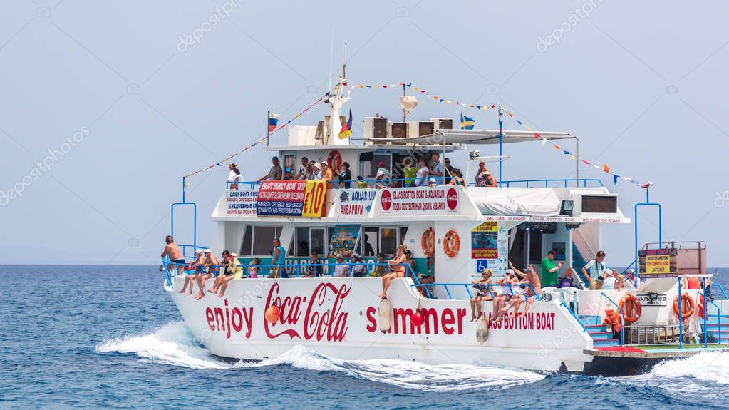 PROTARAS, CYPRUS - JUNE 4, 2019: Coca Cola boat with tourists in the Mediterranean Sea