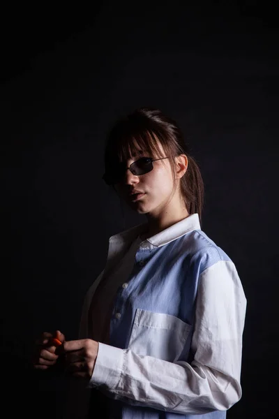 Caucasian Girl in white shirt with black sunglasses posing in the studio — Stock Photo, Image