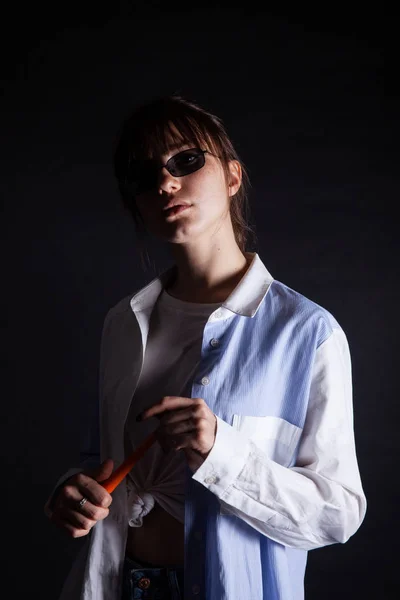 Caucasian Girl in white shirt with black sunglasses posing in the studio — Stock Photo, Image