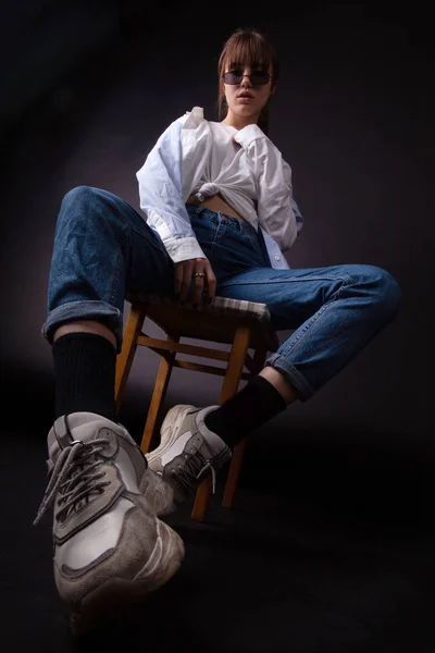 Caucasian Girl in white shirt with black sunglasses posing in the studio — Stock Photo, Image