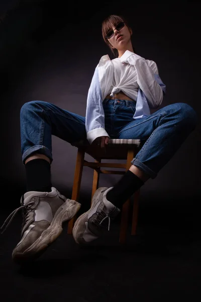 Caucasian Girl in white shirt with black sunglasses posing in the studio — Stock Photo, Image