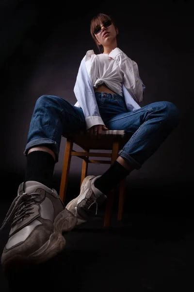 Caucasian Girl in white shirt with black sunglasses posing in the studio — Stock Photo, Image